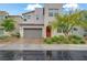 Charming two-story home with a neutral palette, two-car garage, and manicured landscaping at 525 Monarch Ridge Ct, North Las Vegas, NV 89084