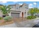 Modern two-story home featuring a two-car garage, arched entryway, and drought-tolerant landscaping at 525 Monarch Ridge Ct, North Las Vegas, NV 89084