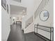 Hallway showcasing a staircase, sleek black and white design, tile flooring, and neutral decor at 525 Monarch Ridge Ct, North Las Vegas, NV 89084