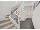 Entryway featuring a modern staircase, black metal railings, tile flooring, and white walls at 525 Monarch Ridge Ct, North Las Vegas, NV 89084