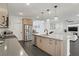 Open kitchen featuring a large island, stainless steel appliances, and modern wood cabinets at 525 Monarch Ridge Ct, North Las Vegas, NV 89084