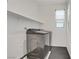 Bright laundry room featuring stainless steel washer and dryer and floating shelf for extra storage at 525 Monarch Ridge Ct, North Las Vegas, NV 89084