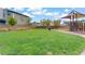 Community playground featuring a shaded play structure and open green space for recreation at 525 Monarch Ridge Ct, North Las Vegas, NV 89084