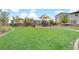 Well-maintained community playground with play structure, picnic table, and lush lawn at 525 Monarch Ridge Ct, North Las Vegas, NV 89084