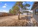 Backyard with a brick walkway, mature trees, and space for outdoor living at 5867 Bunch St, Las Vegas, NV 89122