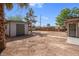 Spacious backyard with a shed and a walkway leading to a building entrance at 5867 Bunch St, Las Vegas, NV 89122