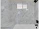 Bright bathroom features elegant marble tiling in the shower and a built in shower seat at 5867 Bunch St, Las Vegas, NV 89122