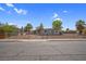 Single story home with a chain link fence and a gray exterior at 5867 Bunch St, Las Vegas, NV 89122
