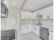 Bright kitchen features stainless steel appliances, quartz countertops, and white cabinets at 5867 Bunch St, Las Vegas, NV 89122