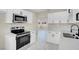 Bright kitchen features stainless steel appliances, quartz countertops, and white cabinets at 5867 Bunch St, Las Vegas, NV 89122