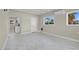Living room with a white ceiling and grey marble floors, looking into the kitchen at 5867 Bunch St, Las Vegas, NV 89122
