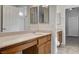 Well-lit bathroom with double sinks, tile flooring, and neutral wall color at 5903 Karnes Ranch Ave, Las Vegas, NV 89131