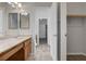 Bright bathroom featuring double sinks, tiled floors, and a walk-in closet at 5903 Karnes Ranch Ave, Las Vegas, NV 89131