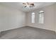 Neutral bedroom with carpet flooring and bright light from the arched windows at 5903 Karnes Ranch Ave, Las Vegas, NV 89131