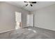 Neutral bedroom with carpet flooring, ceiling fan, and ensuite bathroom entrance at 5903 Karnes Ranch Ave, Las Vegas, NV 89131