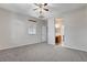 Neutral bedroom with ceiling fan, carpet flooring and ensuite bathroom entrance at 5903 Karnes Ranch Ave, Las Vegas, NV 89131