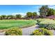A large manicured common area with trees, shrubbery and walking path under a blue sky at 5903 Karnes Ranch Ave, Las Vegas, NV 89131