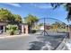 View of the community entrance gate, shrubbery, and private property notices under a clear sky at 5903 Karnes Ranch Ave, Las Vegas, NV 89131