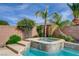 An attached jacuzzi featuring stone steps, water feature, and surrounding desert landscaping at 5903 Karnes Ranch Ave, Las Vegas, NV 89131