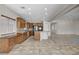 Well-lit kitchen with granite counters, wood cabinets, and built-in workstation at 5903 Karnes Ranch Ave, Las Vegas, NV 89131