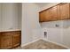 Laundry room with tiled floors, wood cabinets, and utility sink at 5903 Karnes Ranch Ave, Las Vegas, NV 89131