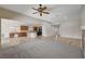 Large living space flows into a kitchen with dark wood cabinets and modern appliances at 5903 Karnes Ranch Ave, Las Vegas, NV 89131