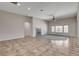 Spacious living area with a modern fireplace, ceiling fan, and a large window for natural light at 5903 Karnes Ranch Ave, Las Vegas, NV 89131