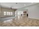Bright, open-concept living area with tiled floors, a ceiling fan, and large windows at 5903 Karnes Ranch Ave, Las Vegas, NV 89131