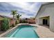 Private backyard pool with waterfall feature and covered patio at 5903 Karnes Ranch Ave, Las Vegas, NV 89131