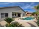 A backyard pool with a small attached jacuzzi and desert landscaping under a clear blue sky at 5903 Karnes Ranch Ave, Las Vegas, NV 89131