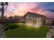 Spacious backyard with artificial grass, a concrete patio, basketball hoop, desert landscaping, and privacy fence at 5965 Sierra Medina Ave, Las Vegas, NV 89139
