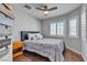 Inviting bedroom with wood floors, neutral walls, plantation shutters, and ceiling fan for a cozy atmosphere at 5965 Sierra Medina Ave, Las Vegas, NV 89139