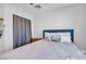 Cozy bedroom features soft decor, a bed with decorative pillows, and gray curtains at 5965 Sierra Medina Ave, Las Vegas, NV 89139