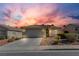 Single-story home with desert landscaping, a tile roof, and two-car garage at sunset at 5965 Sierra Medina Ave, Las Vegas, NV 89139