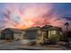 Exterior view of home with tile roof, desert landscaping, and beautiful sunset at 5965 Sierra Medina Ave, Las Vegas, NV 89139