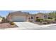 Charming single-story home featuring a tile roof, two-car garage, desert landscaping, and a spacious driveway at 5965 Sierra Medina Ave, Las Vegas, NV 89139