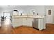 Kitchen area with stainless steel dishwasher, white cabinetry, and breakfast bar at 5965 Sierra Medina Ave, Las Vegas, NV 89139