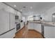 Bright kitchen featuring sleek white cabinetry, stainless appliances, and hardwood floors at 5965 Sierra Medina Ave, Las Vegas, NV 89139