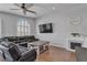 Cozy living room featuring a fireplace, hardwood floors, and a comfortable leather sectional at 5965 Sierra Medina Ave, Las Vegas, NV 89139