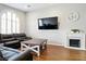 Welcoming living room with hardwood floors, plush seating, and a decorative fireplace at 5965 Sierra Medina Ave, Las Vegas, NV 89139