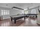 Living room featuring a pool table, hardwood floors, large windows, and modern lighting at 5965 Sierra Medina Ave, Las Vegas, NV 89139