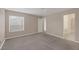 Neutrally decorated bedroom featuring a large window and gray carpeted floor at 6250 W Flamingo Rd # 51, Las Vegas, NV 89103