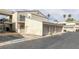 Condominium featuring stucco walls, tile roofing, attached garage, and a second-floor entrance with stairs at 6250 W Flamingo Rd # 51, Las Vegas, NV 89103