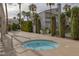 Community hot tub with lounge seating, mature landscaping, and a view of the condo buildings at 6250 W Flamingo Rd # 51, Las Vegas, NV 89103