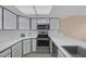 Bright kitchen features stainless steel appliances, gray cabinets and new countertops at 6250 W Flamingo Rd # 51, Las Vegas, NV 89103