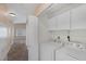 Functional laundry room with a washer, dryer, and storage cabinets offers convenience and organization at 6250 W Flamingo Rd # 51, Las Vegas, NV 89103