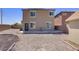 View of the home's backyard showing the home's exterior, desert landscaping, and perimeter fencing at 626 Taliput Palm Pl, Henderson, NV 89011