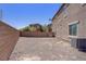 This home's backyard features block wall fencing, minimal landscaping, and the home's side exterior at 626 Taliput Palm Pl, Henderson, NV 89011
