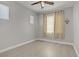 This room features a ceiling fan, two windows, wood-look flooring, and neutral-colored walls at 626 Taliput Palm Pl, Henderson, NV 89011