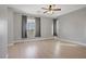 Spacious bedroom with modern ceiling fan, light wood floors, and neutral paint at 626 Taliput Palm Pl, Henderson, NV 89011